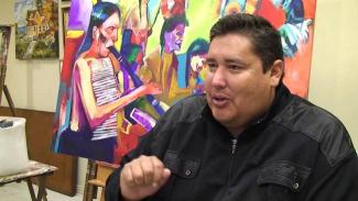 Brent Learned in front of one of his paintings